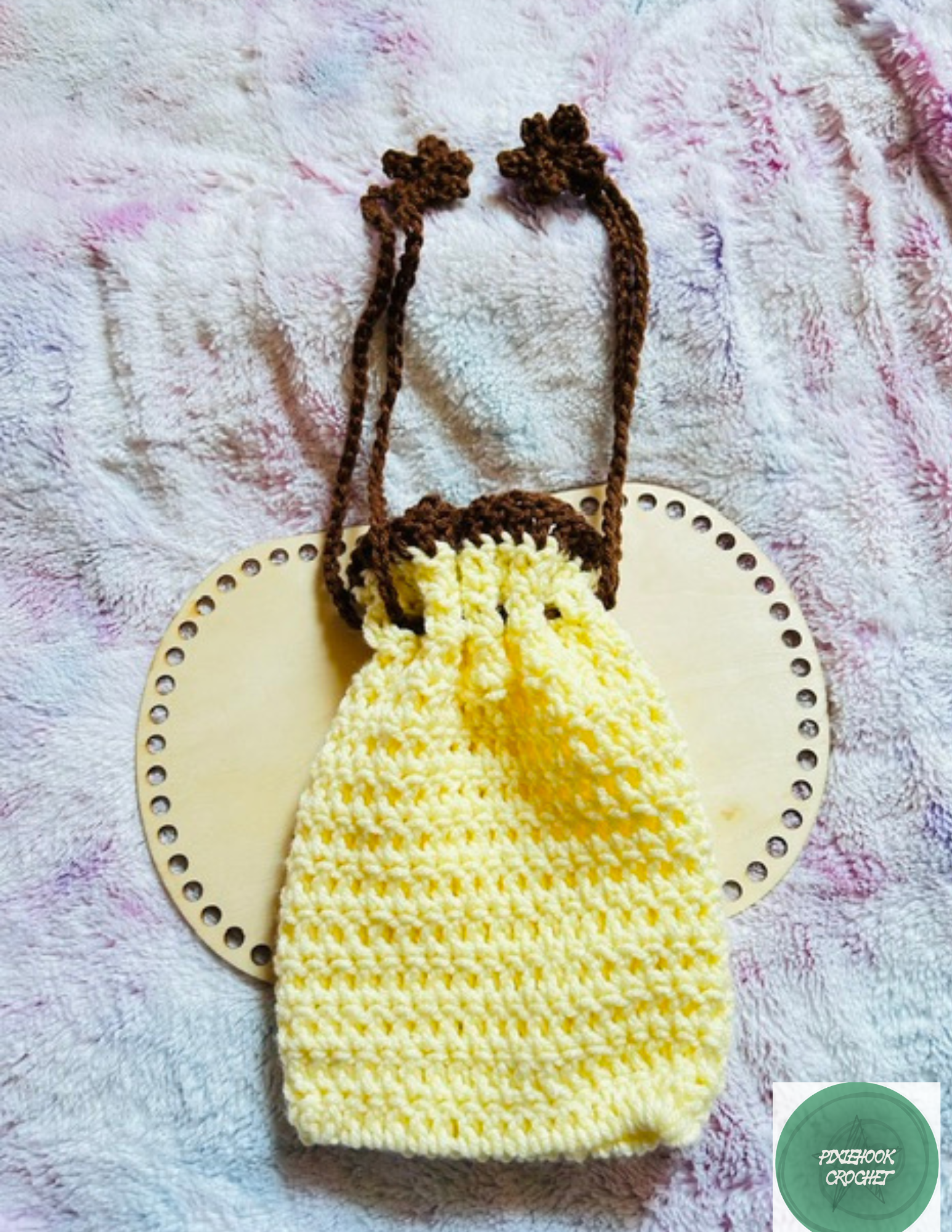 Handmade yellow crochet drawstring bag with brown drawstring